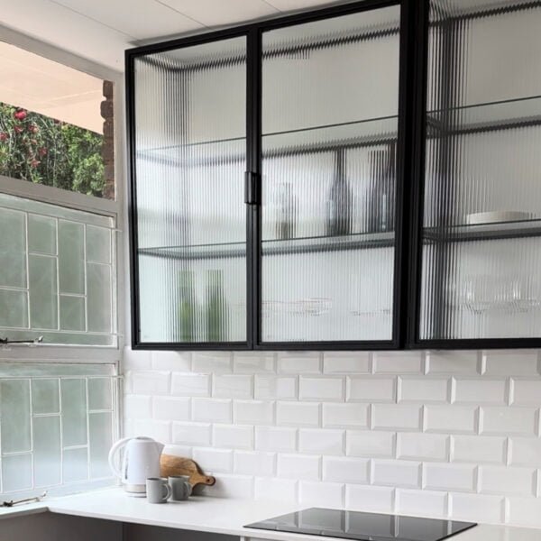 STUDIO DELTA GLASS AND STEEL KITCHEN CABINET IN BLACK